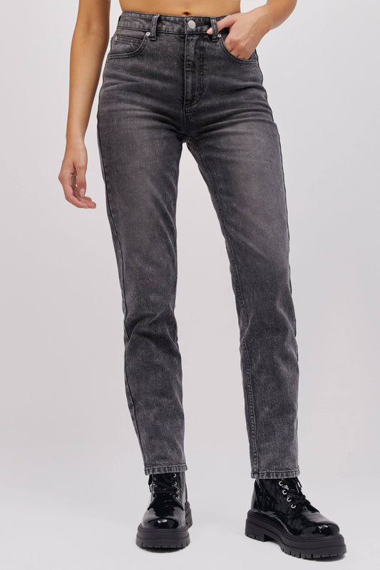 A model featuring a sharp turn colored high rise and straight-legged jeans with a slim fit through the hips.