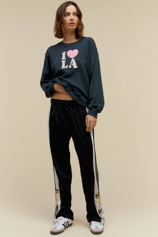 A model featuring a black crew sweatshirt stamped with I love LA.