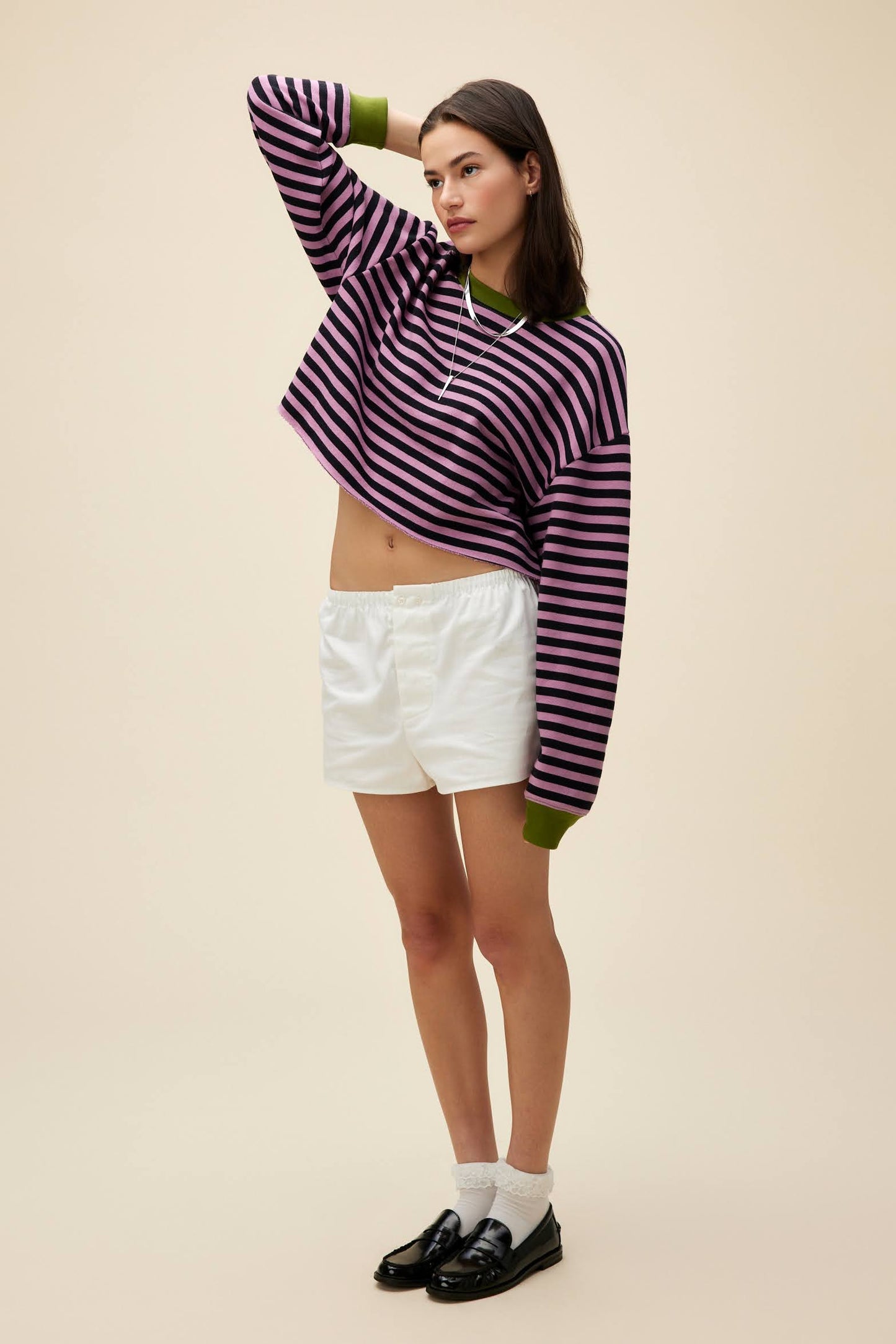 A model featuring a striped cut-off sweatshirt in lotus flower combo