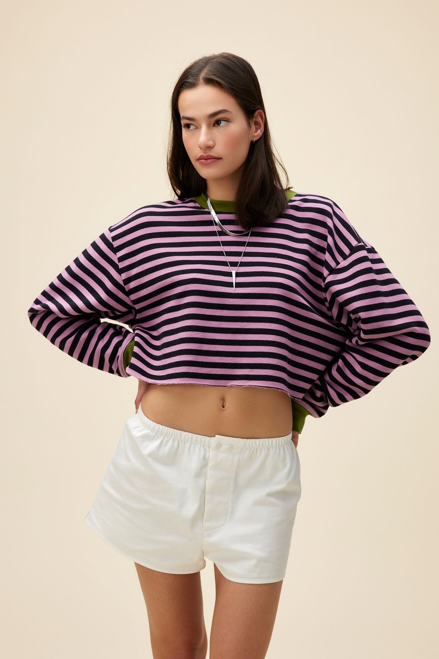 A model featuring a striped cut-off sweatshirt in lotus flower combo