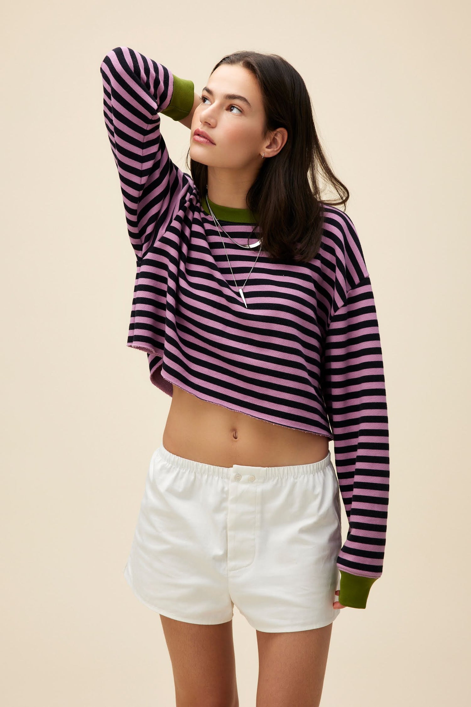 A model featuring a striped cut-off sweatshirt in lotus flower combo