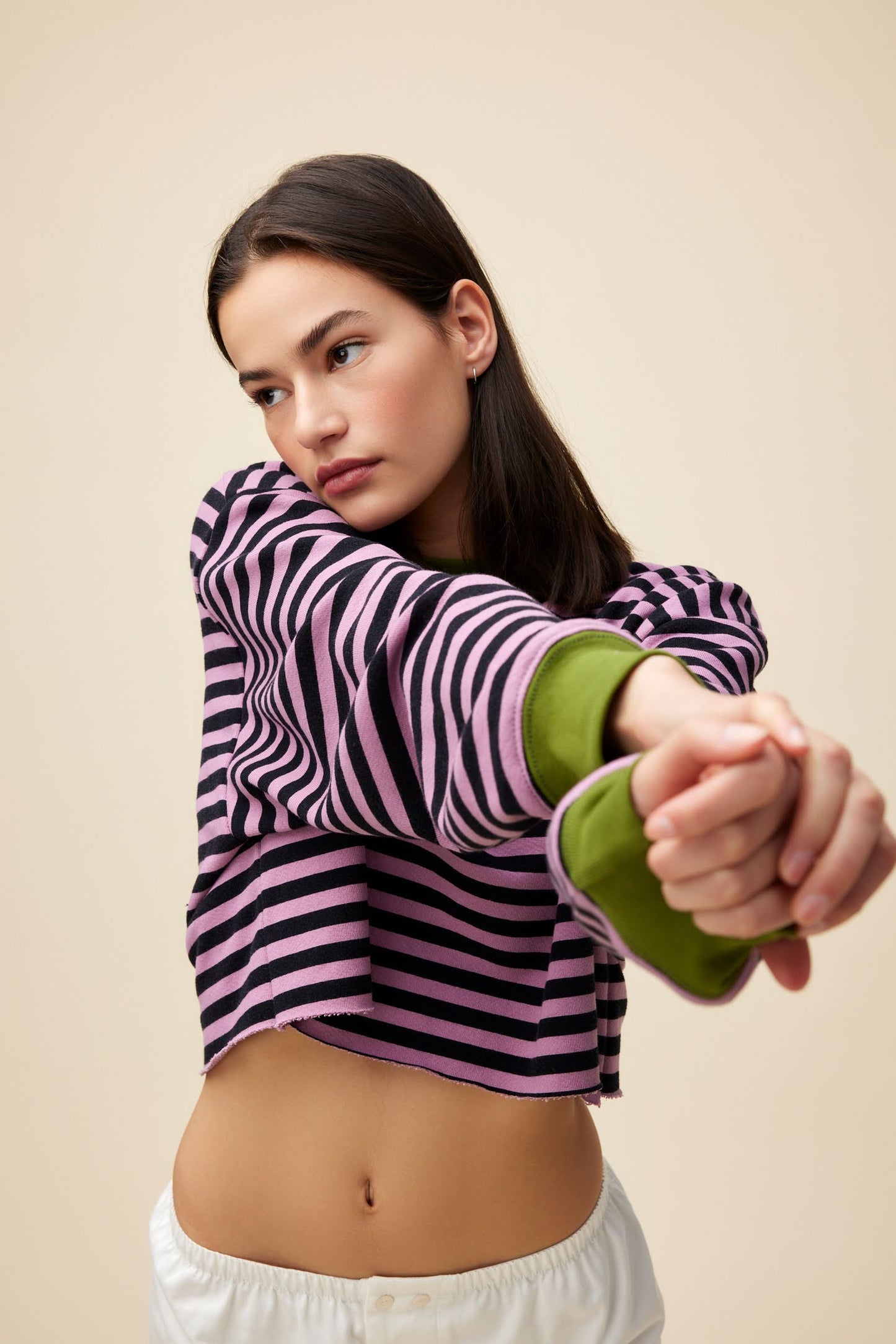 A model featuring a striped cut-off sweatshirt in lotus flower combo