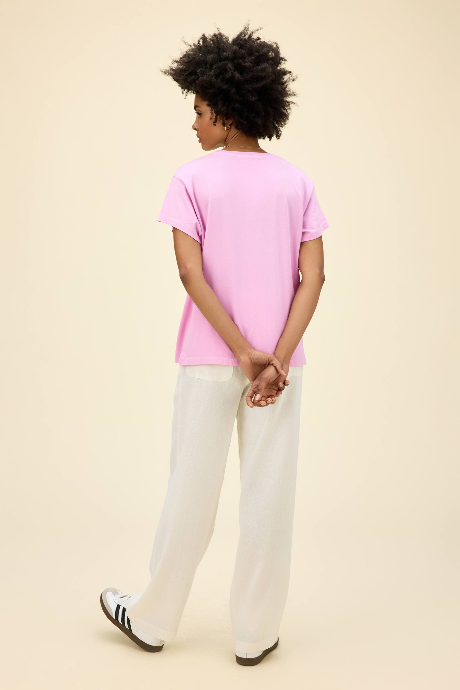 A model featuring a tour tee in faded lilac.