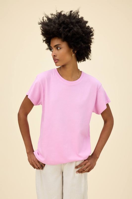 A model featuring a tour tee in faded lilac.