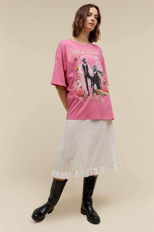A model featuring a pink OS tee with a graphic of the band's logo.