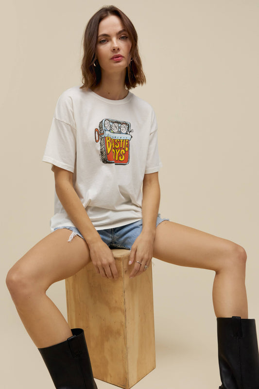 A model featuring a white tee with a graphic  design and stamped with 'Beastie Boys'.