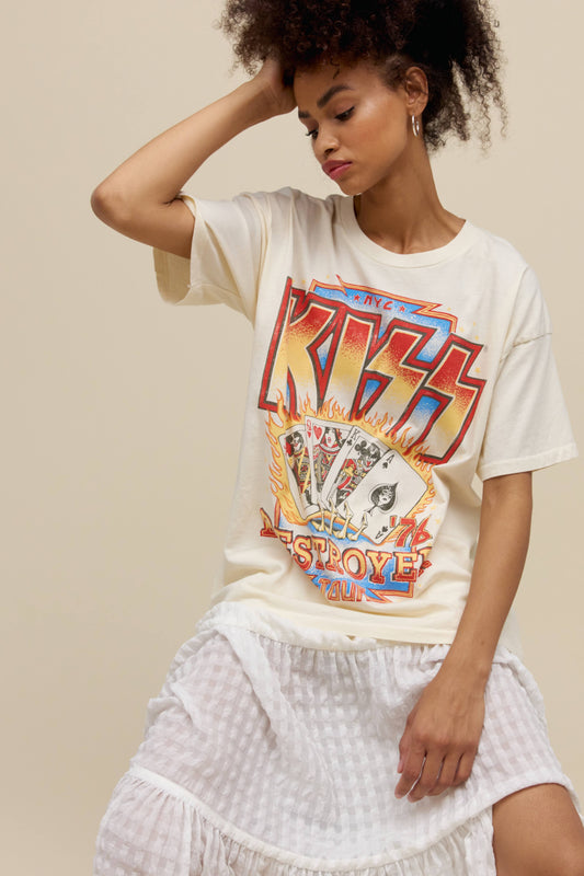 A model featuring a white merch tee stamped with 'KISS' in large font.