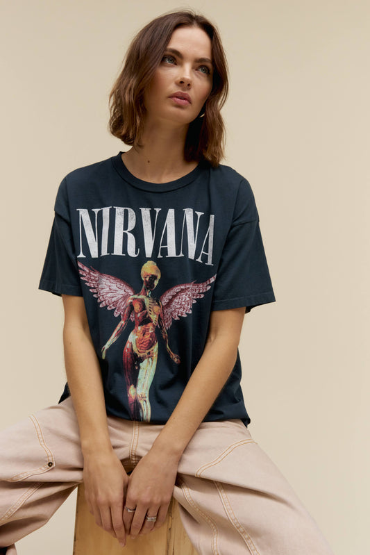 A model featuring a black colored merch tee stamped with Nirvana's Utero album cover.