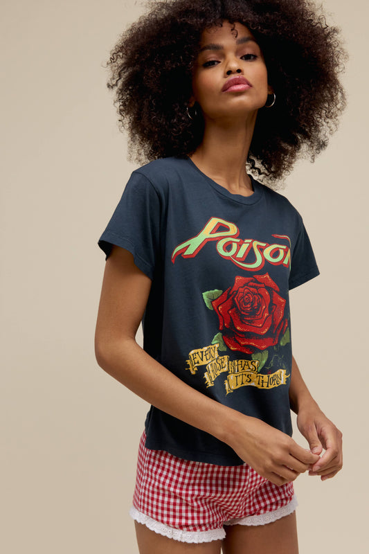 A model featuring a black solo tee stamped with 'Poison Every Flower Has Its Thorn' and a graphic of a rose on the middle.