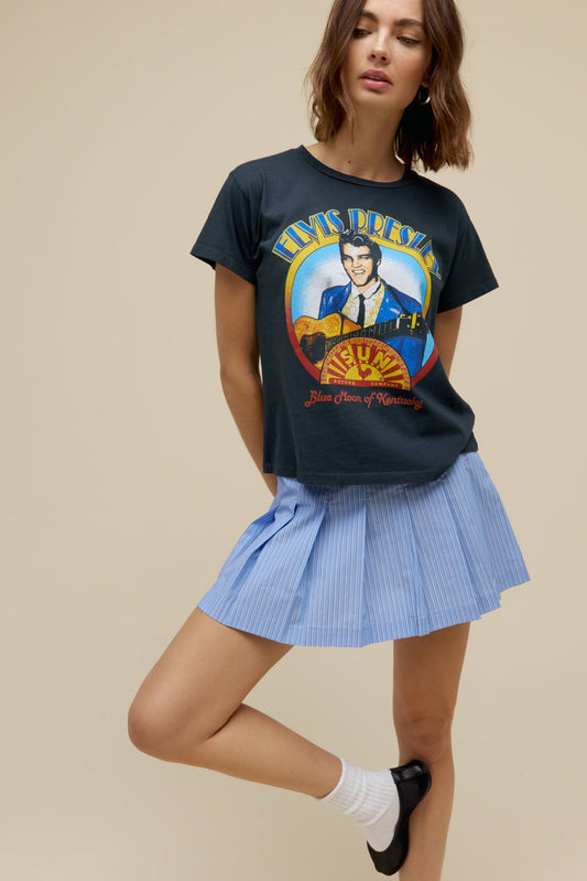 A model featuring a black solo tee stamped with 'Elvis Presley' and his portrait.