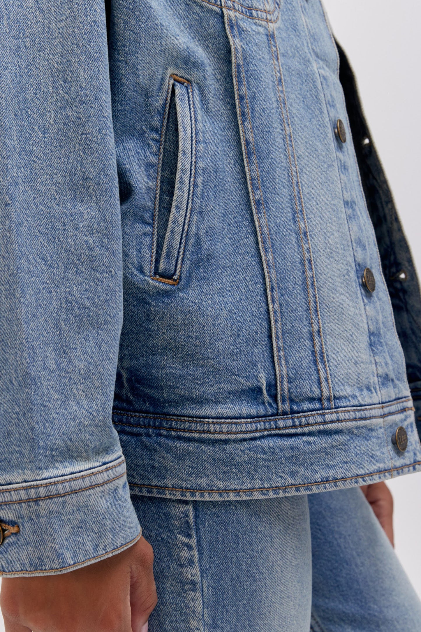 Close up side pocket detail photo of a reimagined Lee Denim rider jacket in an oversized fit.