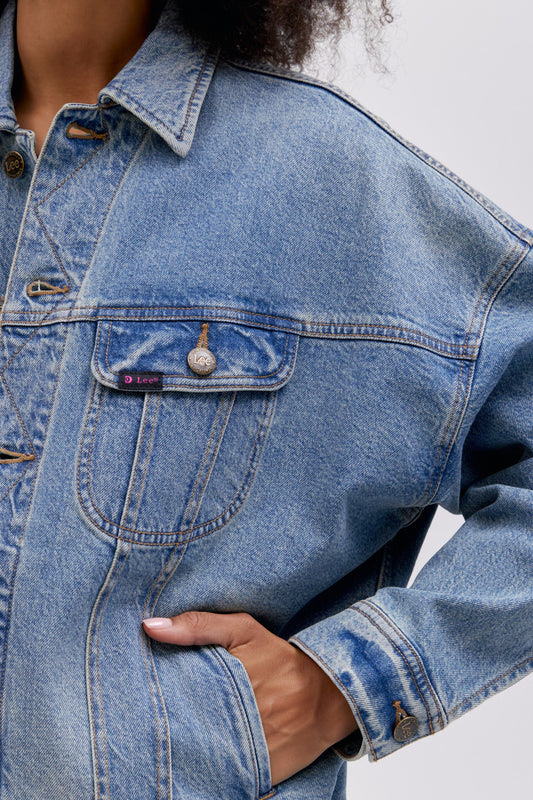 Close up chest pocket detail photo of a reimagined Lee Denim rider jacket in an oversized fit.