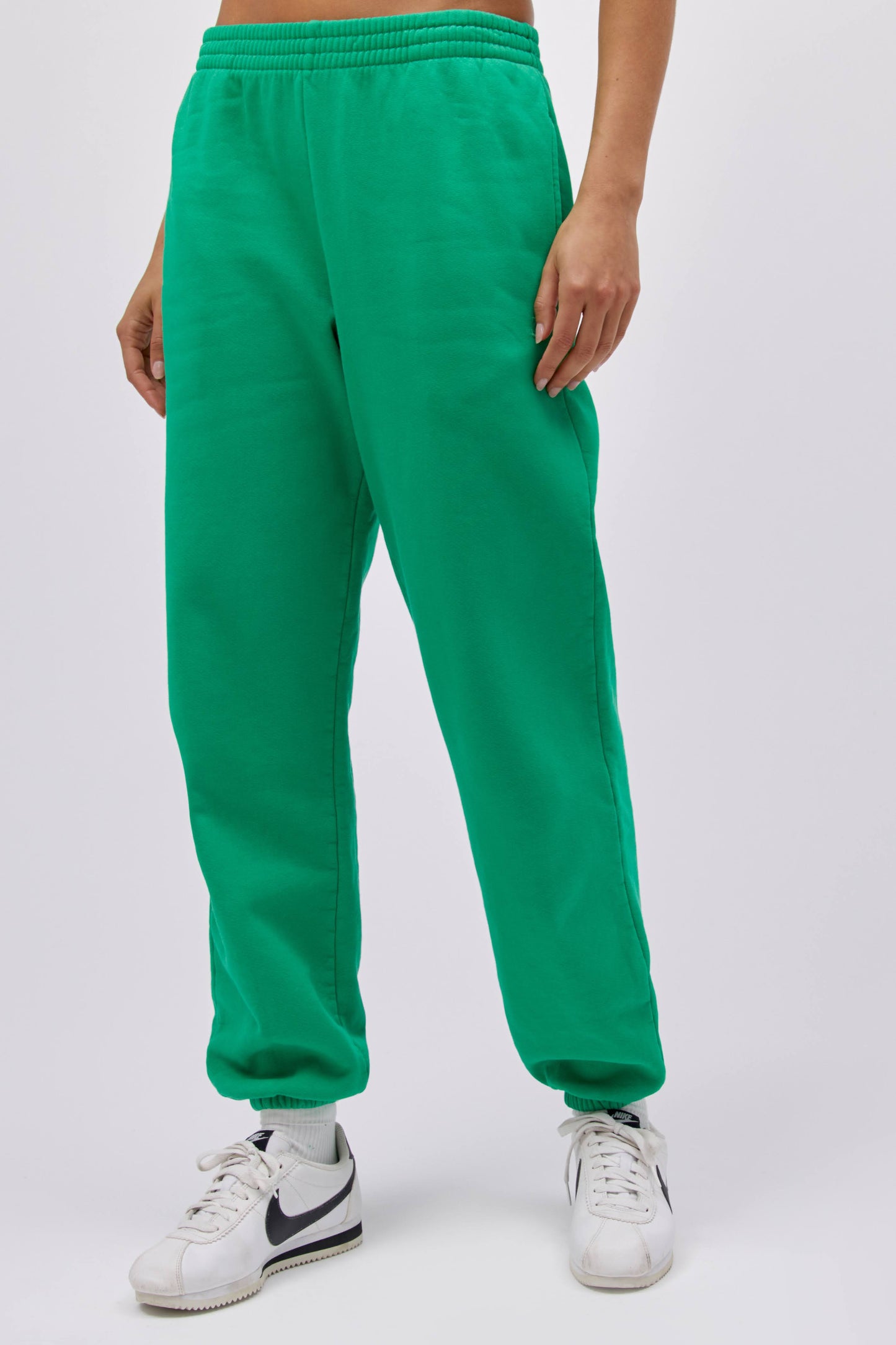 Model wearing a boyfriend sweatpant in lucky green.