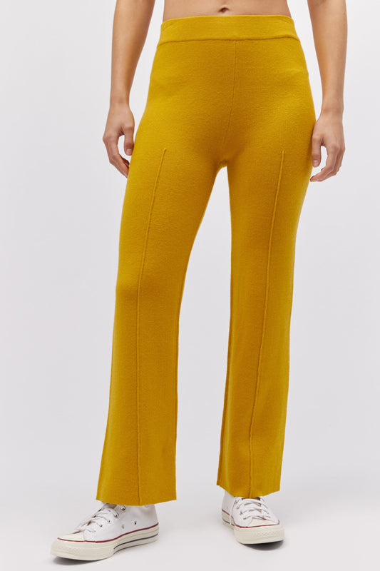 A model featuring a gold pintuck pant.