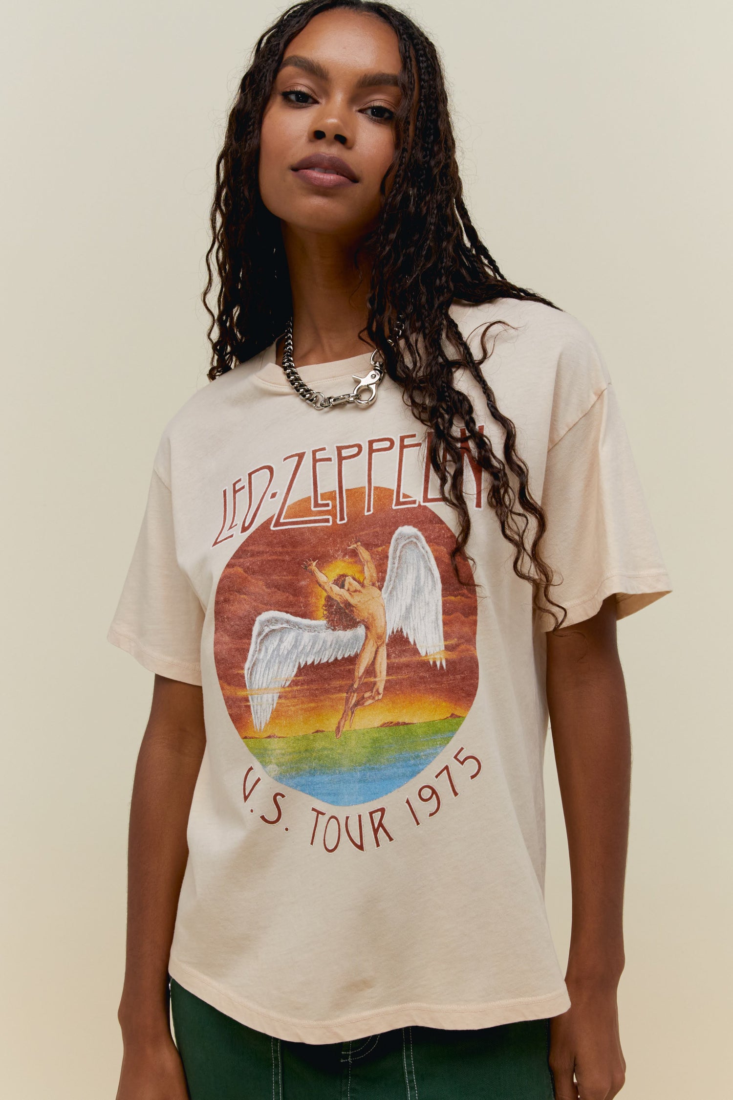 A model featuring a Led Zeppelin boyfriend tee stamped with "LED ZEPPELIN US TOUR 1975" and graphic design of an angel in the middle.