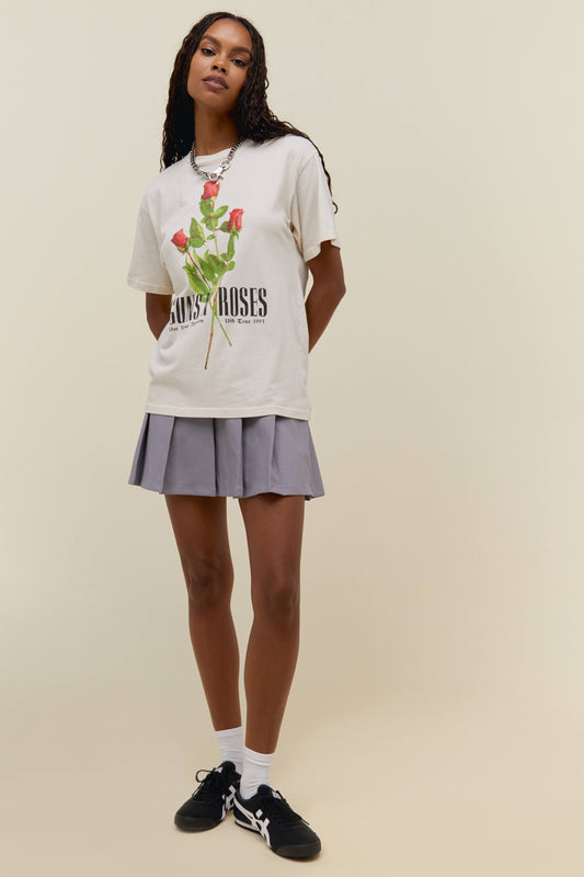 A model featuring a white weekend tee designed with flowers in the muddke and stamped with 'Guns N' Roses'