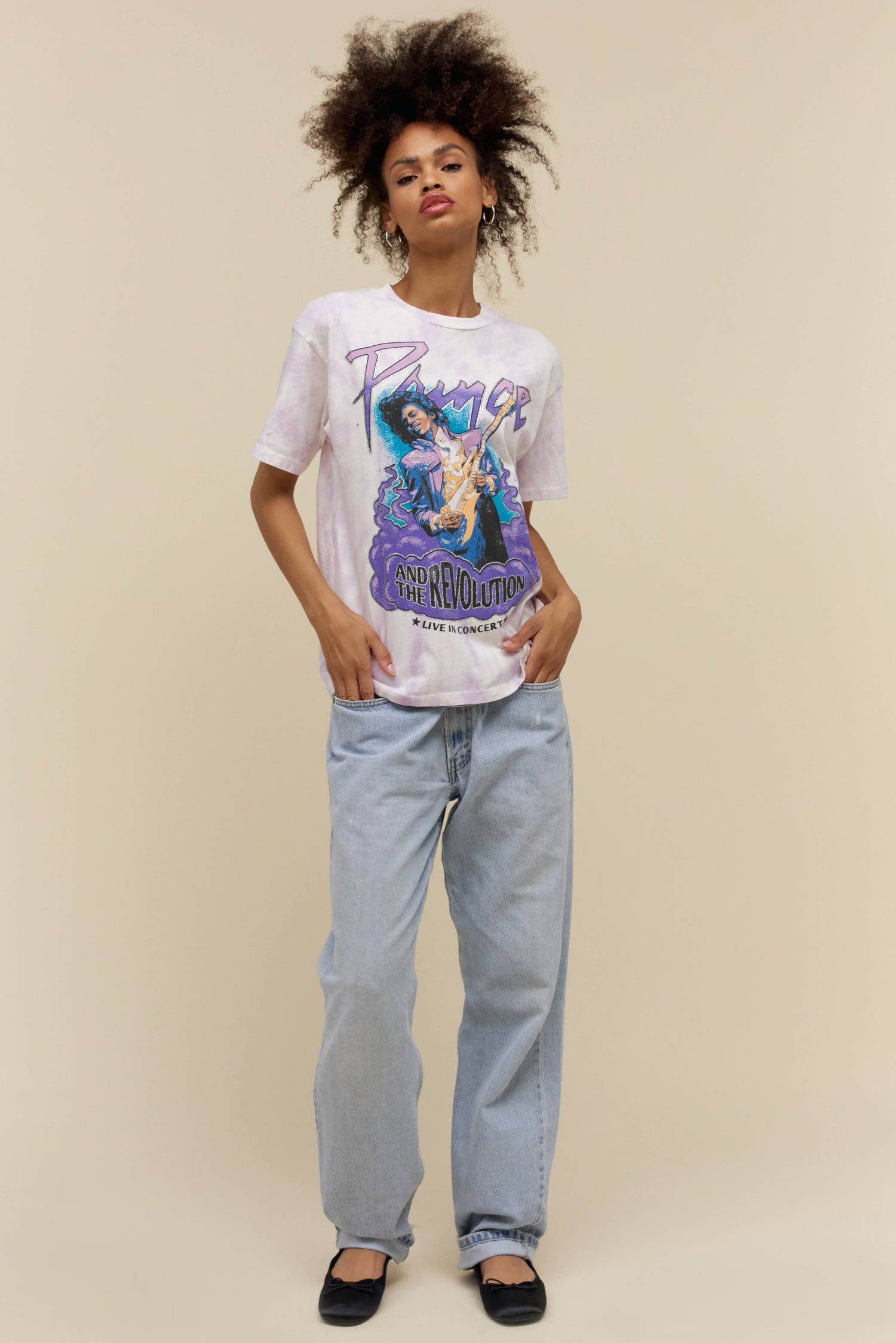 A model featuring a white tee designed with a photo of Prince performing at a concert.
