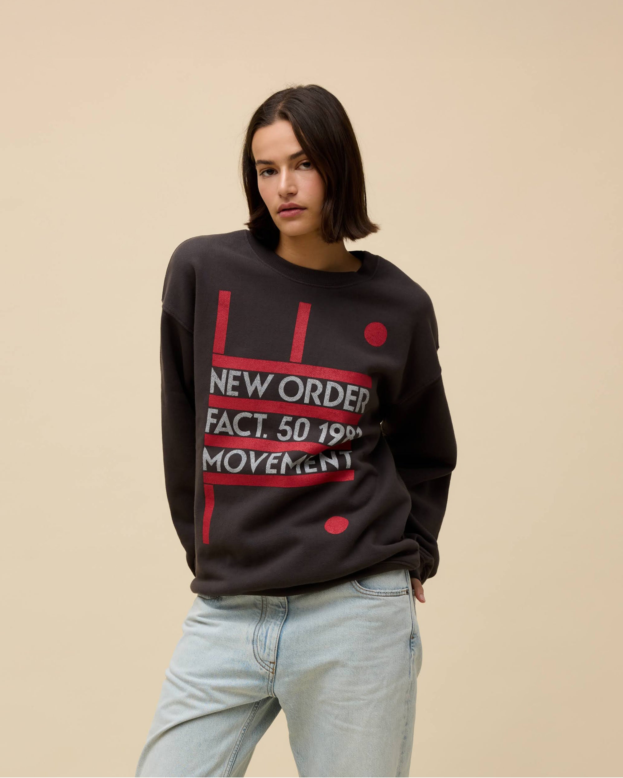Model wearing a black New Order 'Movement' album graphic sweatshirt 