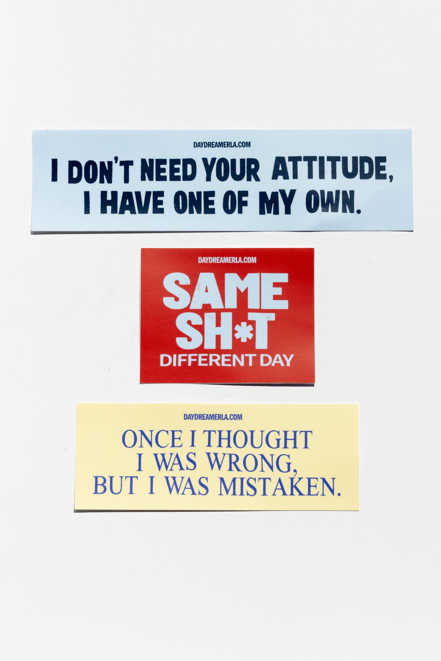 Bumper stickers with 'Tongue In Cheek' slogan graphics in a variety of sizes and colors