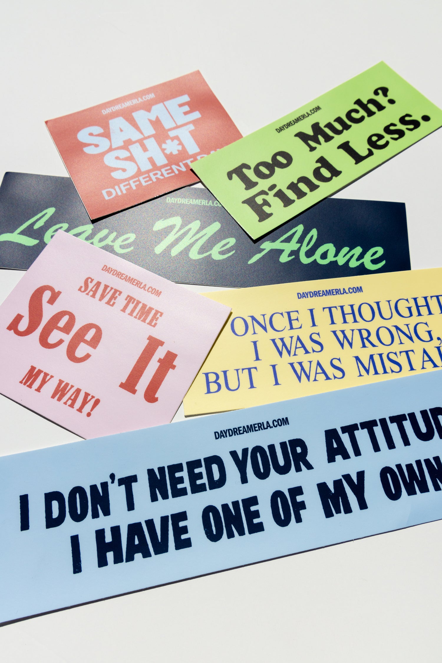 Bumper stickers with 'Tongue In Cheek' slogan graphics in a variety of sizes and colors