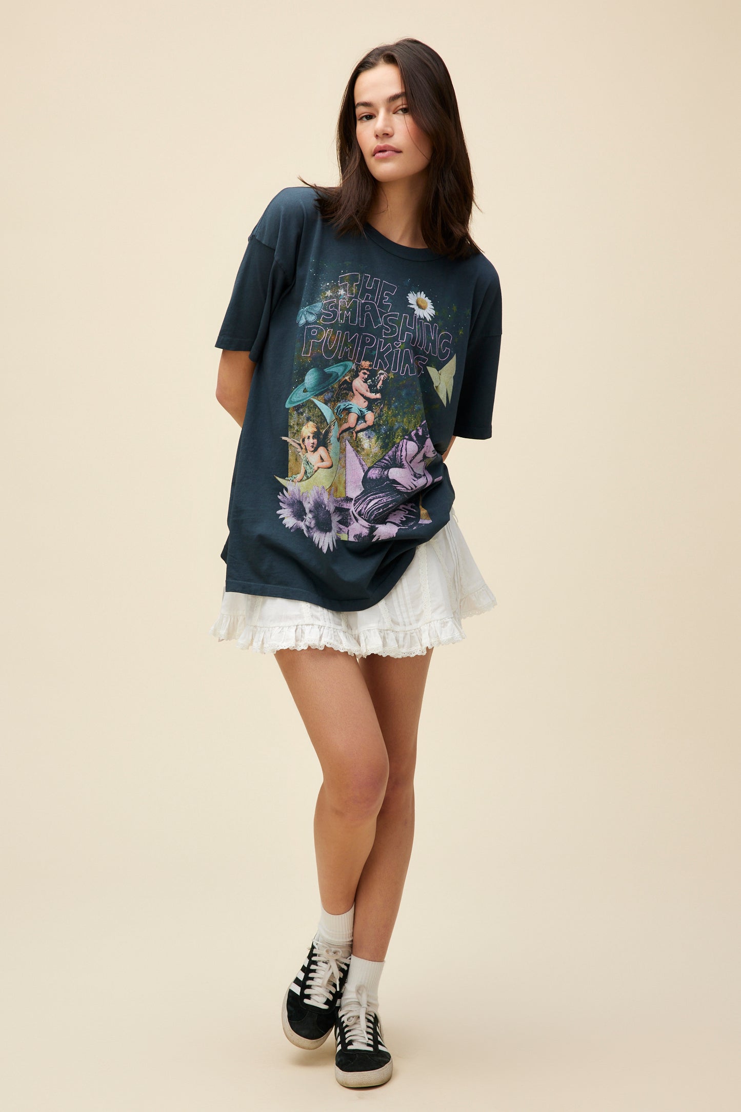 A model featuring a black tee designed with original artwork inspired by the album cover of "Mellon Collie and the Infinite Sadness". 