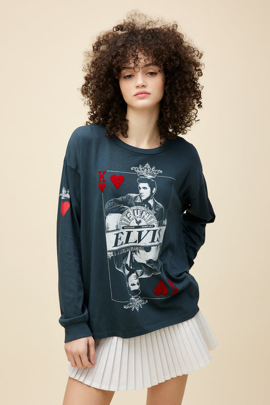 A model featuring a black, loose-fitting long sleeve, finished with red flocked accents on the front to accentuate the classic 'king of hearts' playing card design