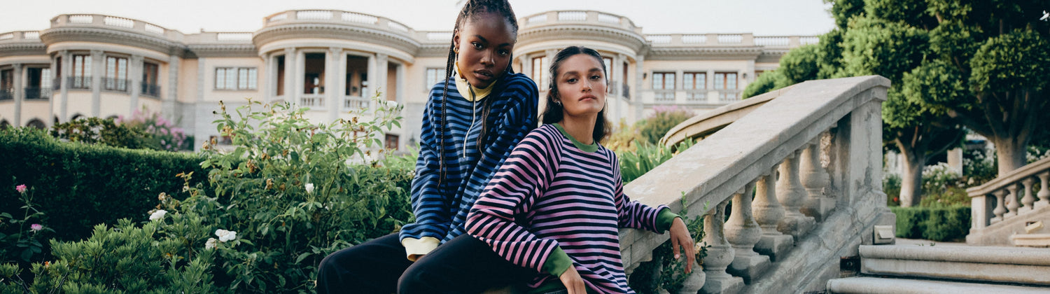 Models wearing colorful striped sweatshirts