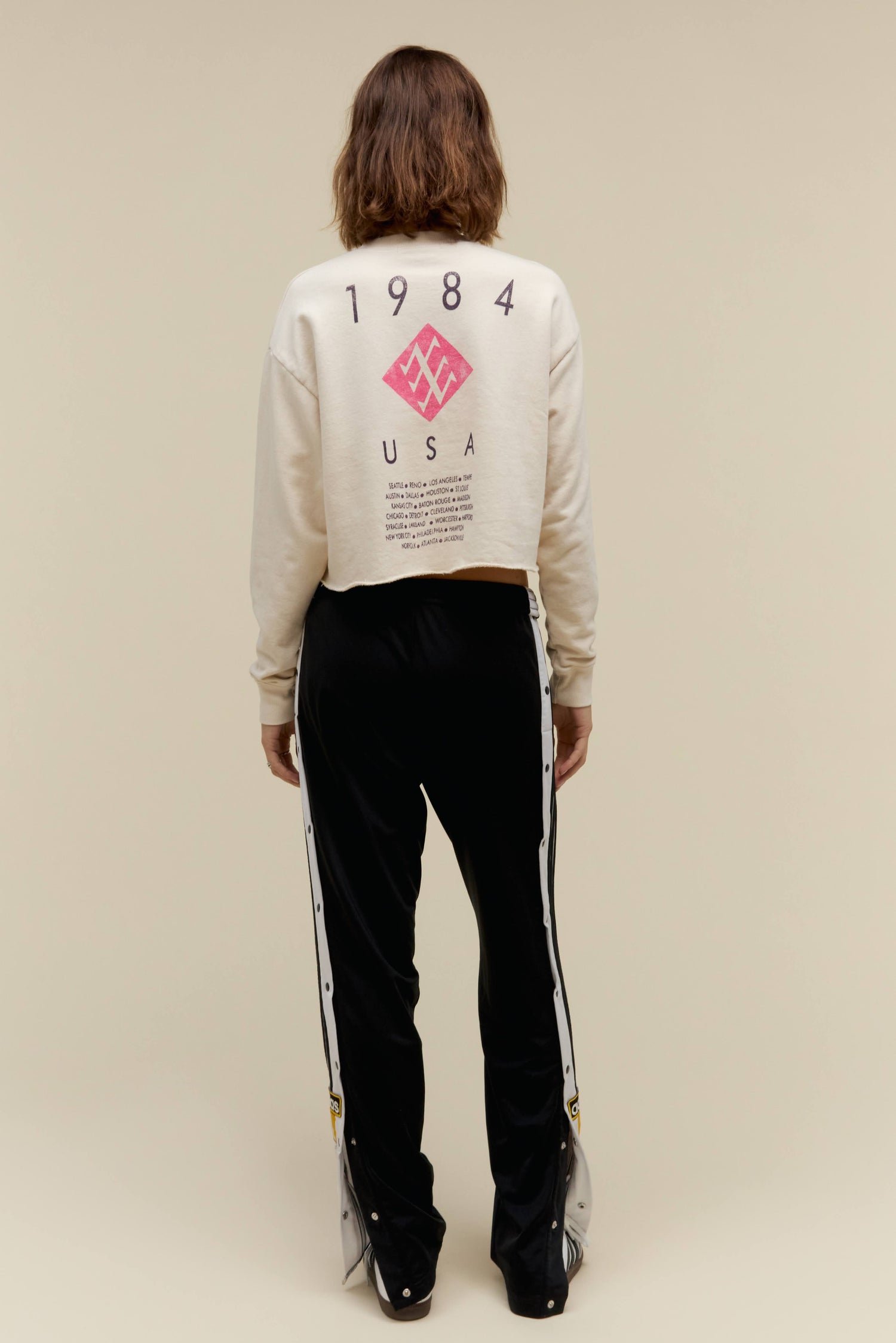 A model featuring a white cropped sweatshirt stamped  with 'Duran Duran'.
