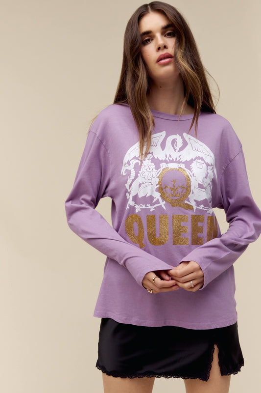 Model wearing a Queen long sleeve graphic tee with crest artwork and gold glitter accents