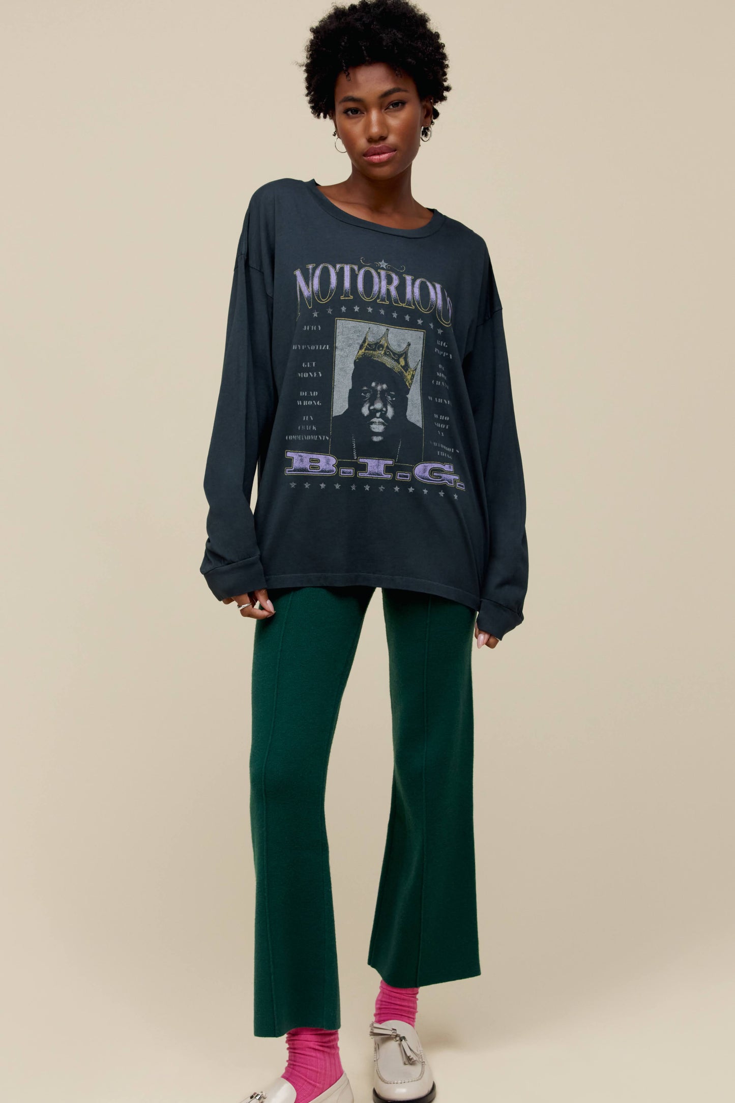 A model featuring a black long sleeve stamped with Notorious and a portrait of the artist.