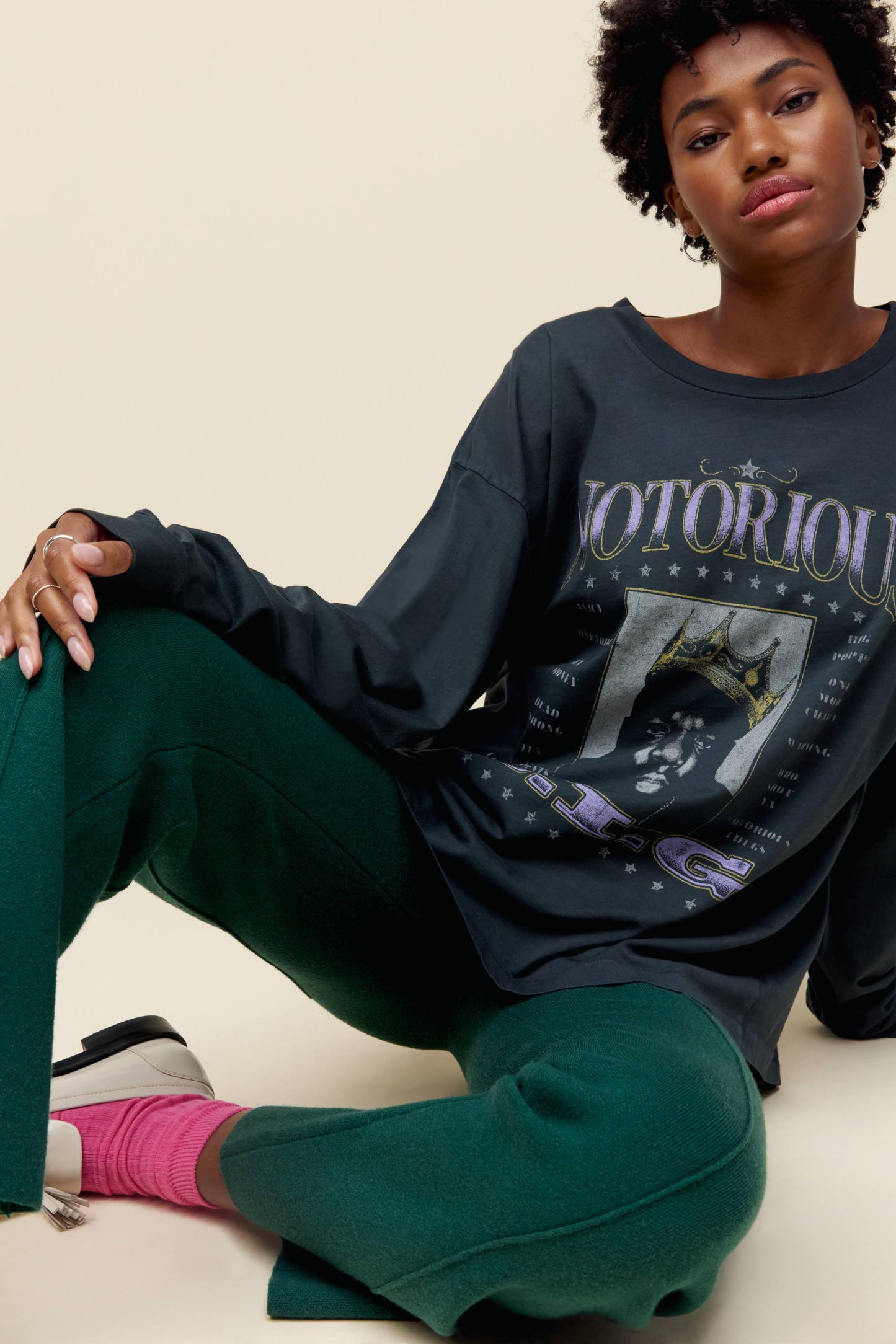 A model featuring a black long sleeve stamped with Notorious and a portrait of the artist itself.