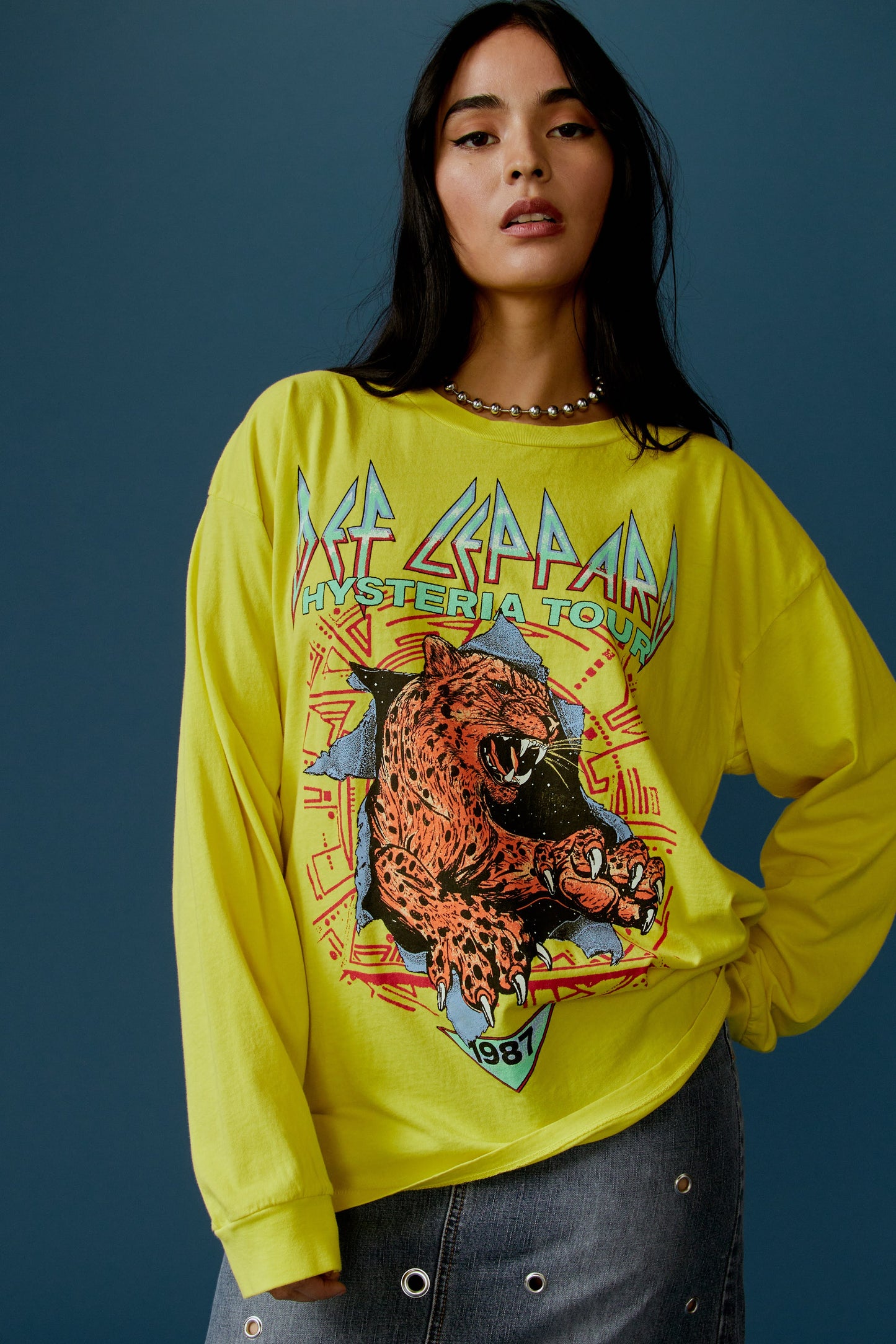 Brunette model in a Def Leppard bright yellow shirt