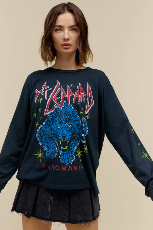 A model featuring a black long sleeve merch with  a blue leppard graphic in the middle.