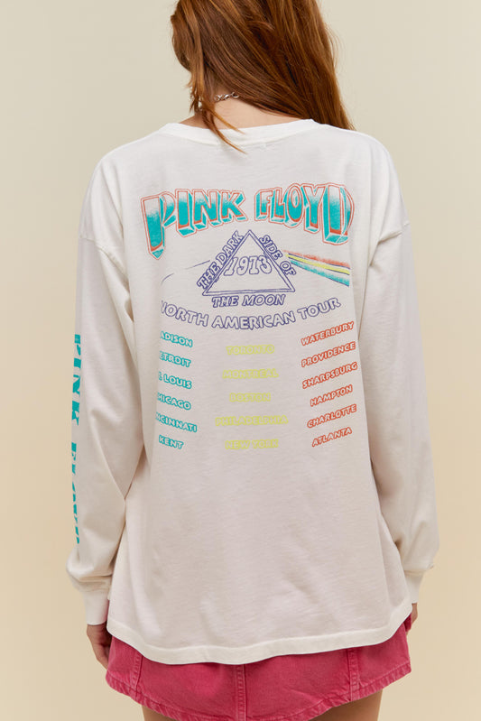 A model featuring a white long sleeve merch stamped with 'Pink Floyd' and a graphic design of the band