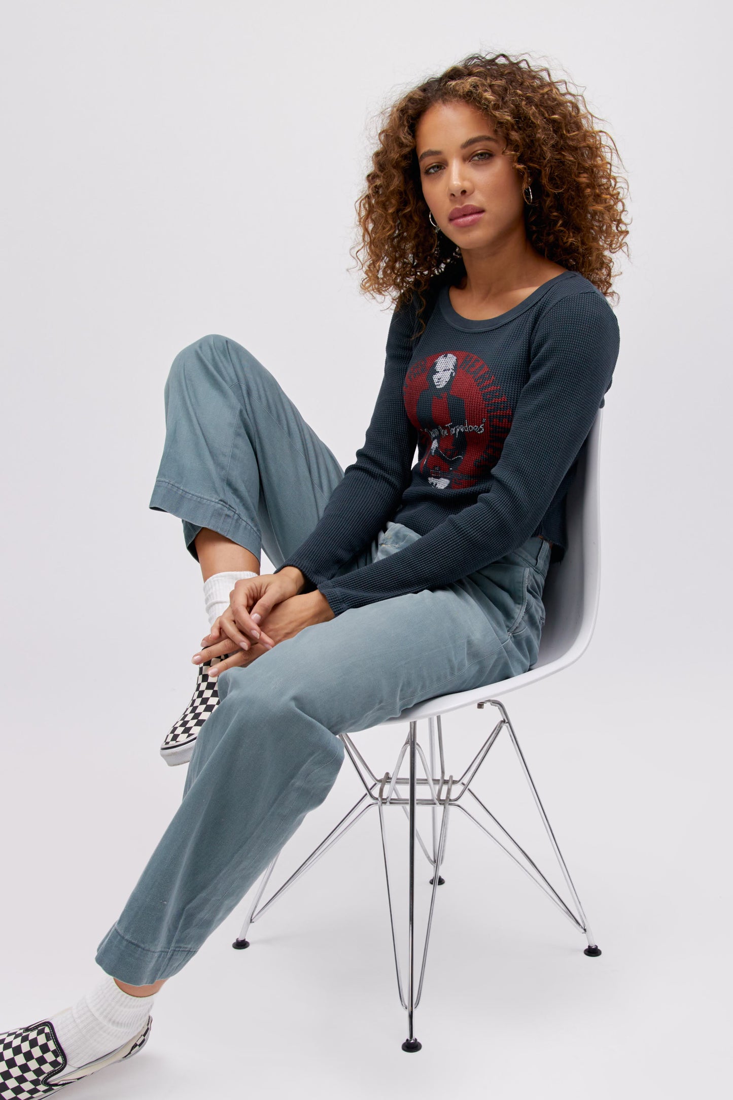 Curly haired model wearing a long sleeve thermal top with Tom Petty 'Damn The Torpedoes' graphic artwork.