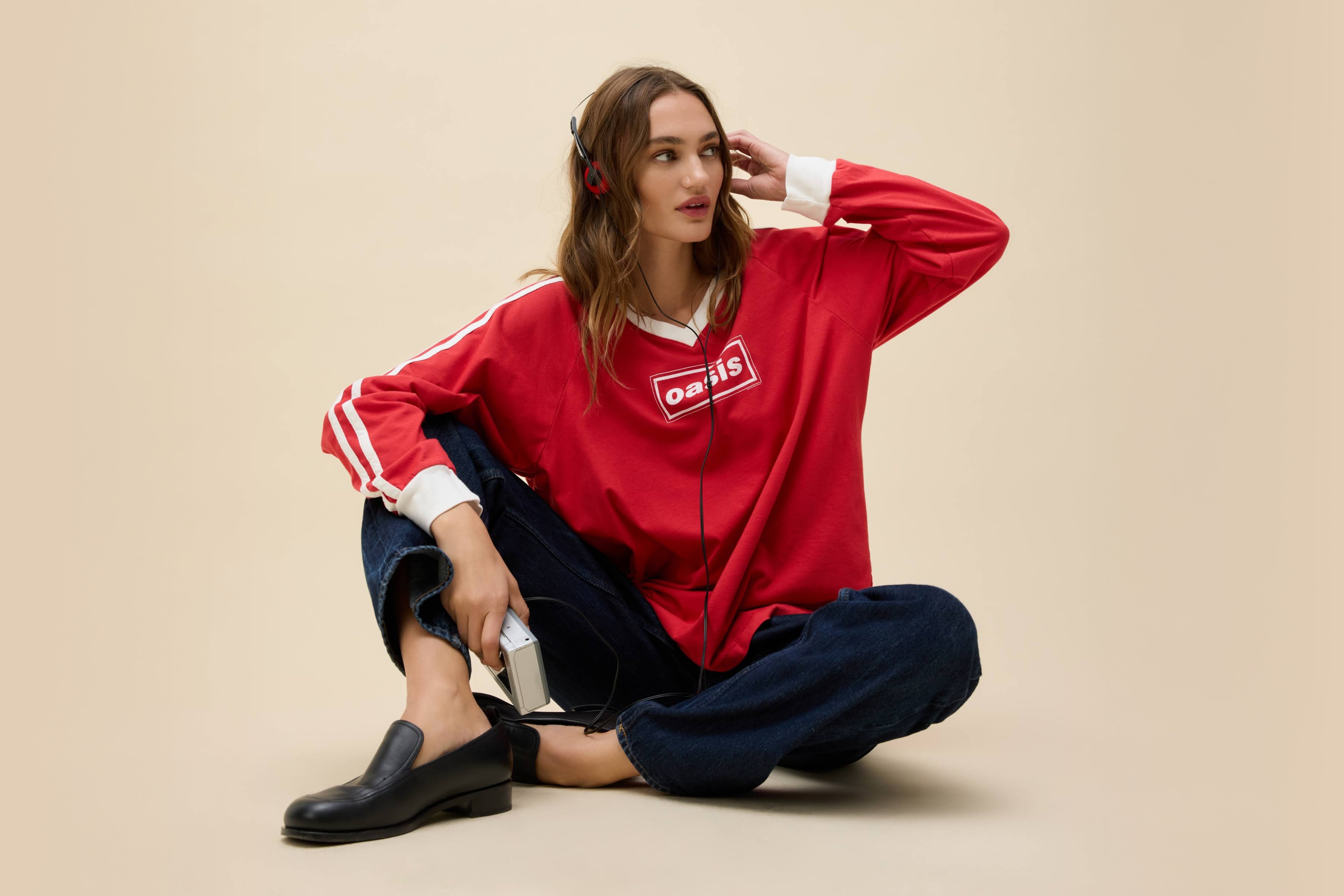 Model wearing an Oasis box logo graphic long sleeve t-shirt in red