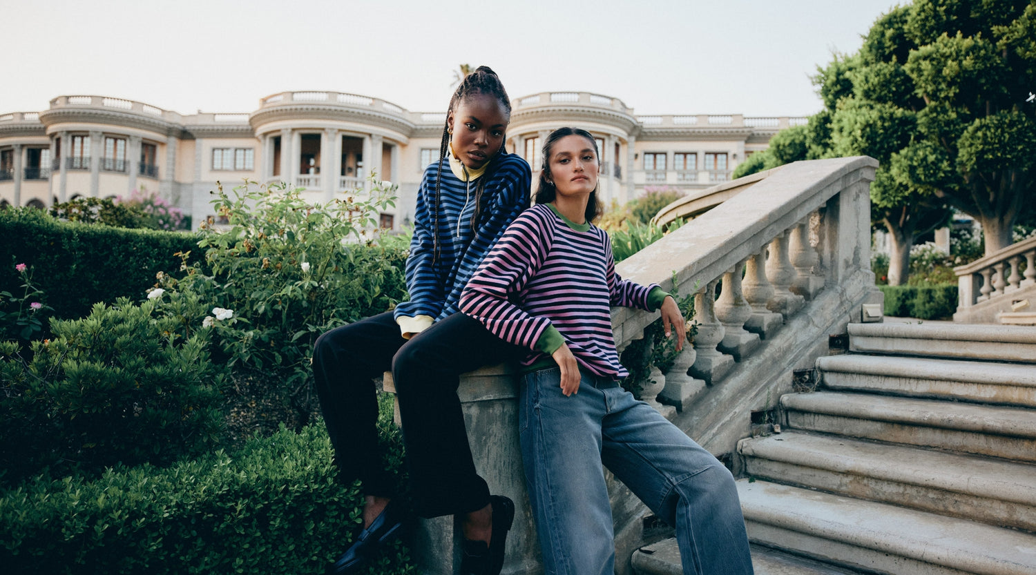 Models wearing colorful striped sweatshirts