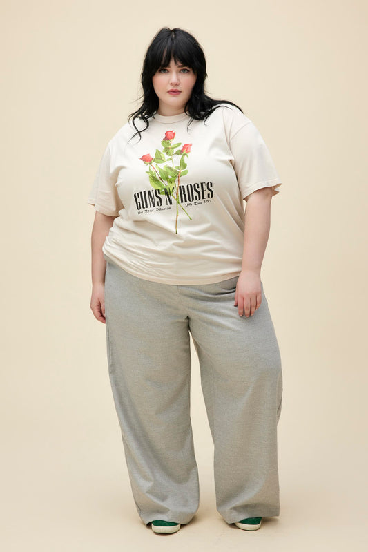 A plus size model featuring a white weekend tee designed with flowers in the muddke and stamped with 'Guns N' Roses'