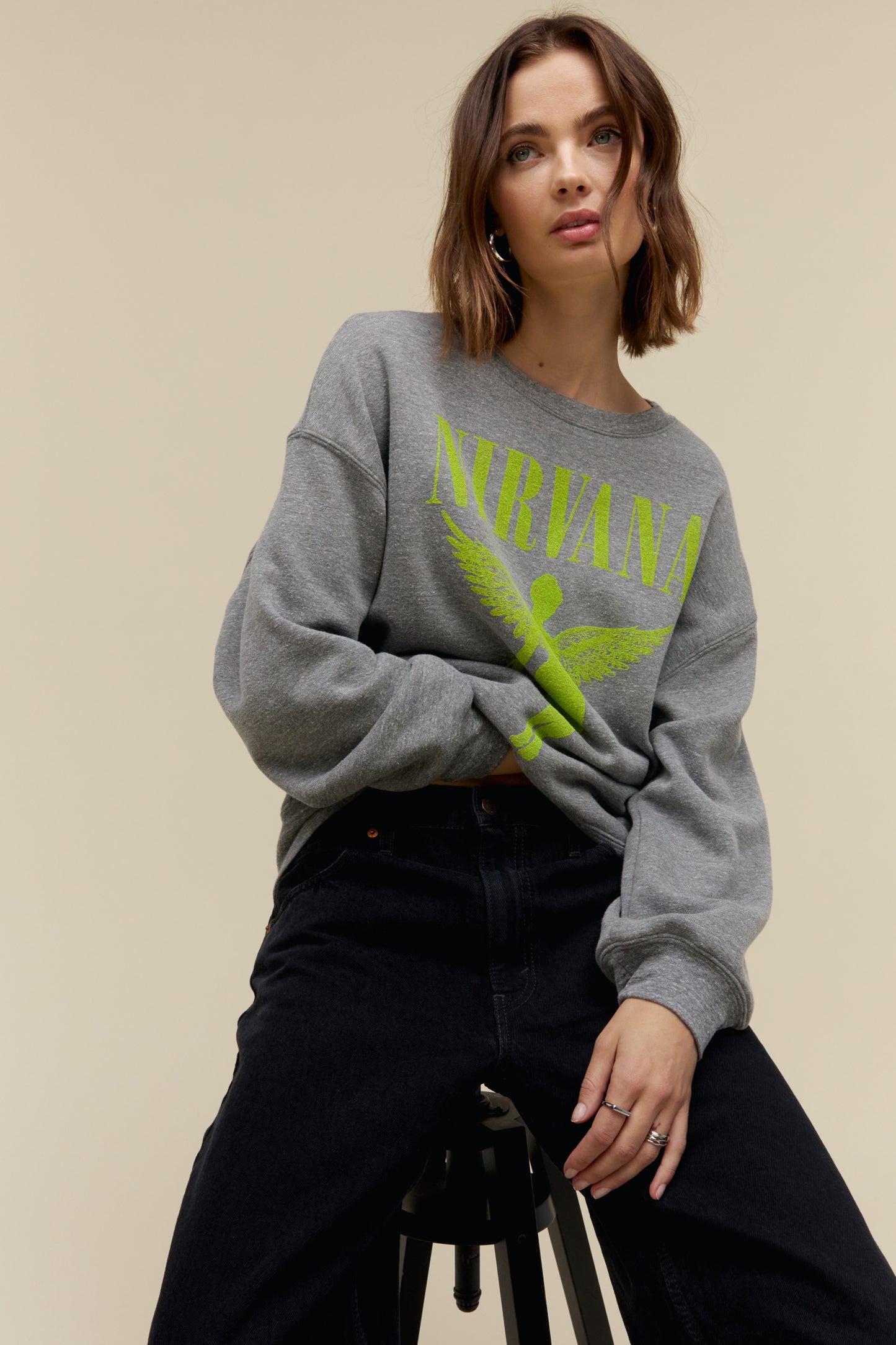 Model wearing an oversized tri-blend fleece sweatshirt with Nirvana 'In Utero' graphics stamped on the front and back