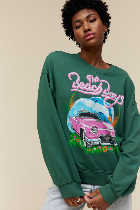 Model wearing The Beach Boys oversized graphic sweatshirt in green