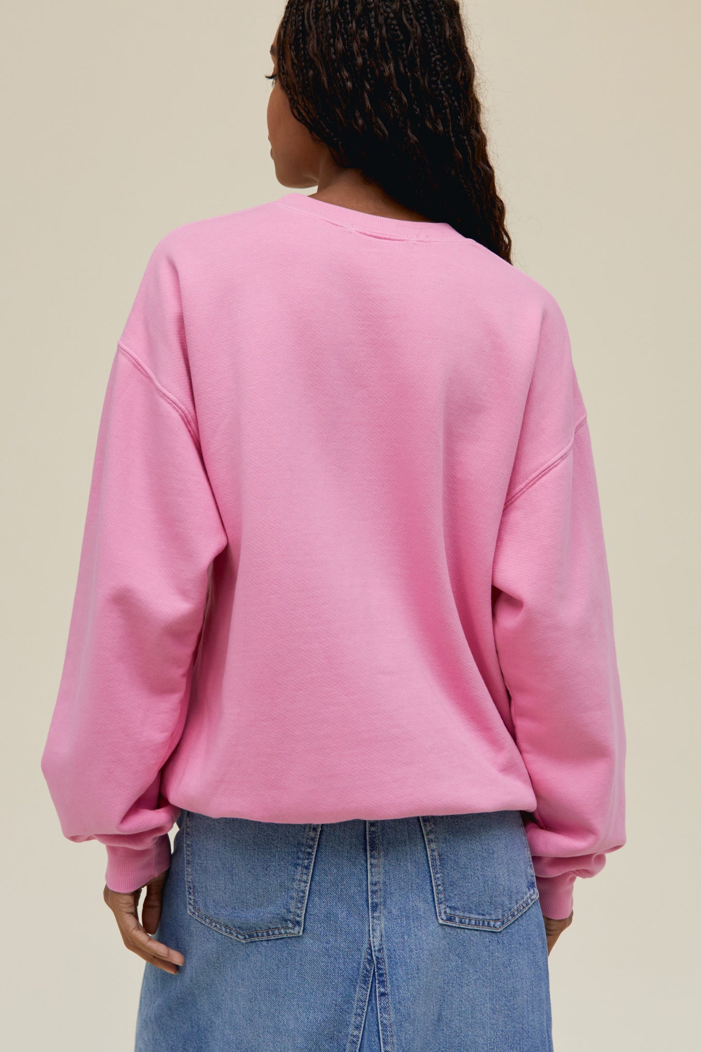 A dark-haired model featuring a pink sweatshirt with a large "THE DOORS" font on top and an exclusive rendition of The Door's Full Circle Album Art 