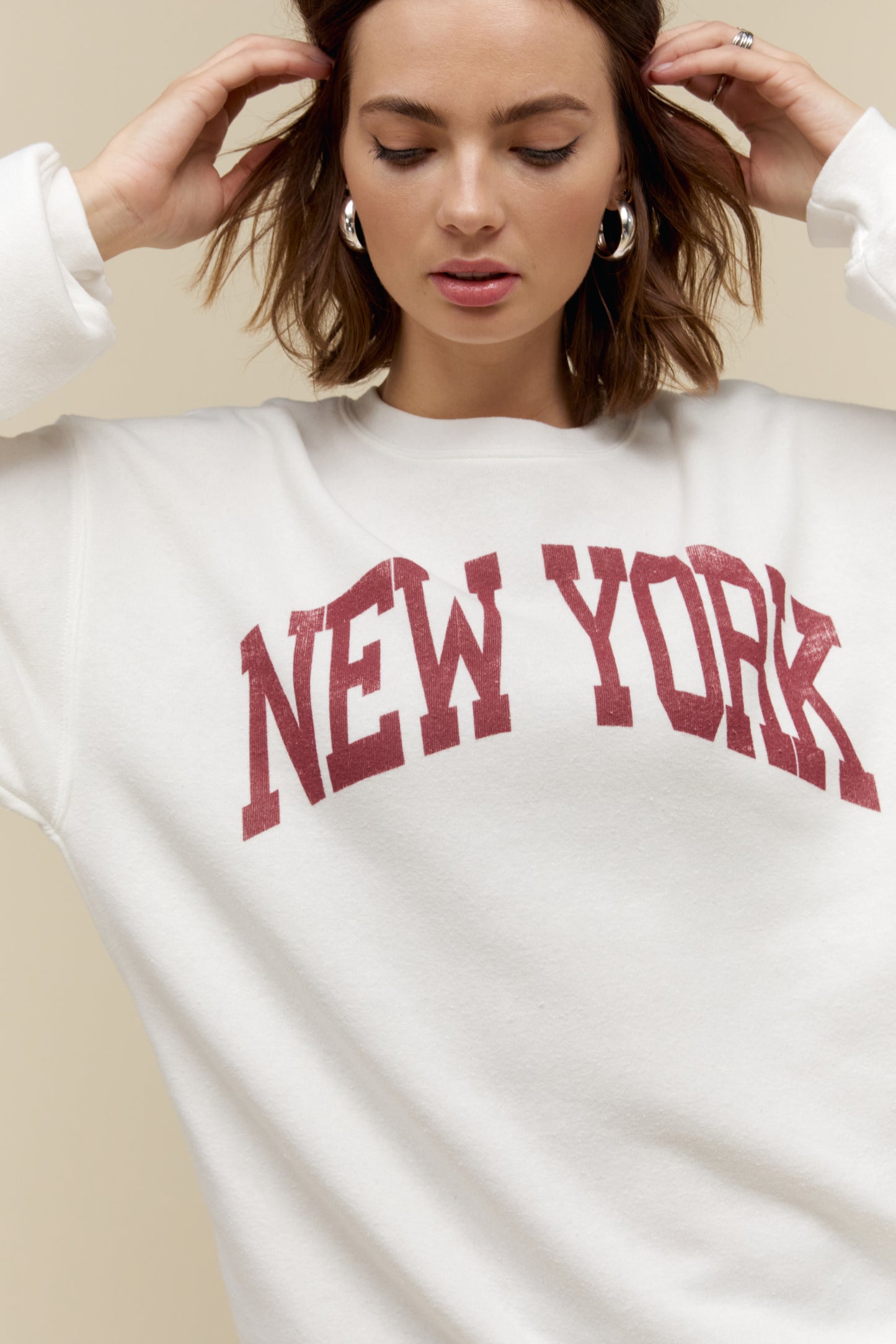 Model wearing a 'New York' collegiate style sweatshirt in a soft tri-blend fleece