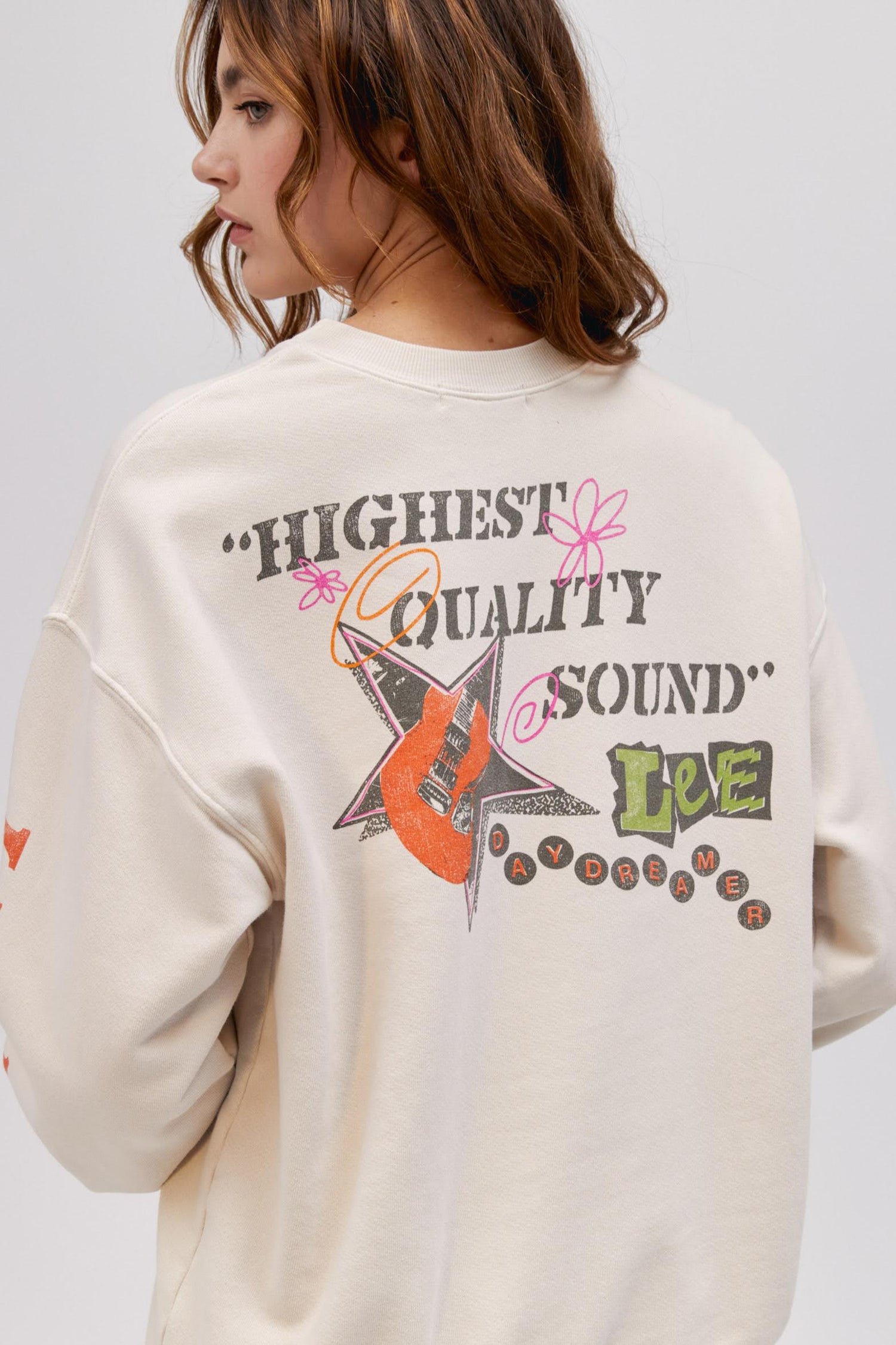 close up back photo of model wearing a washed graphic sweatshirt in off white