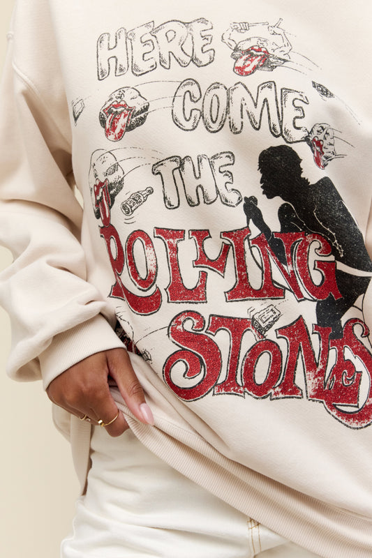 A model featuring a dirty white bf crew stamped with "Here Comes The Rolling Stones" in white and red font, and a silhouette of a man singing.