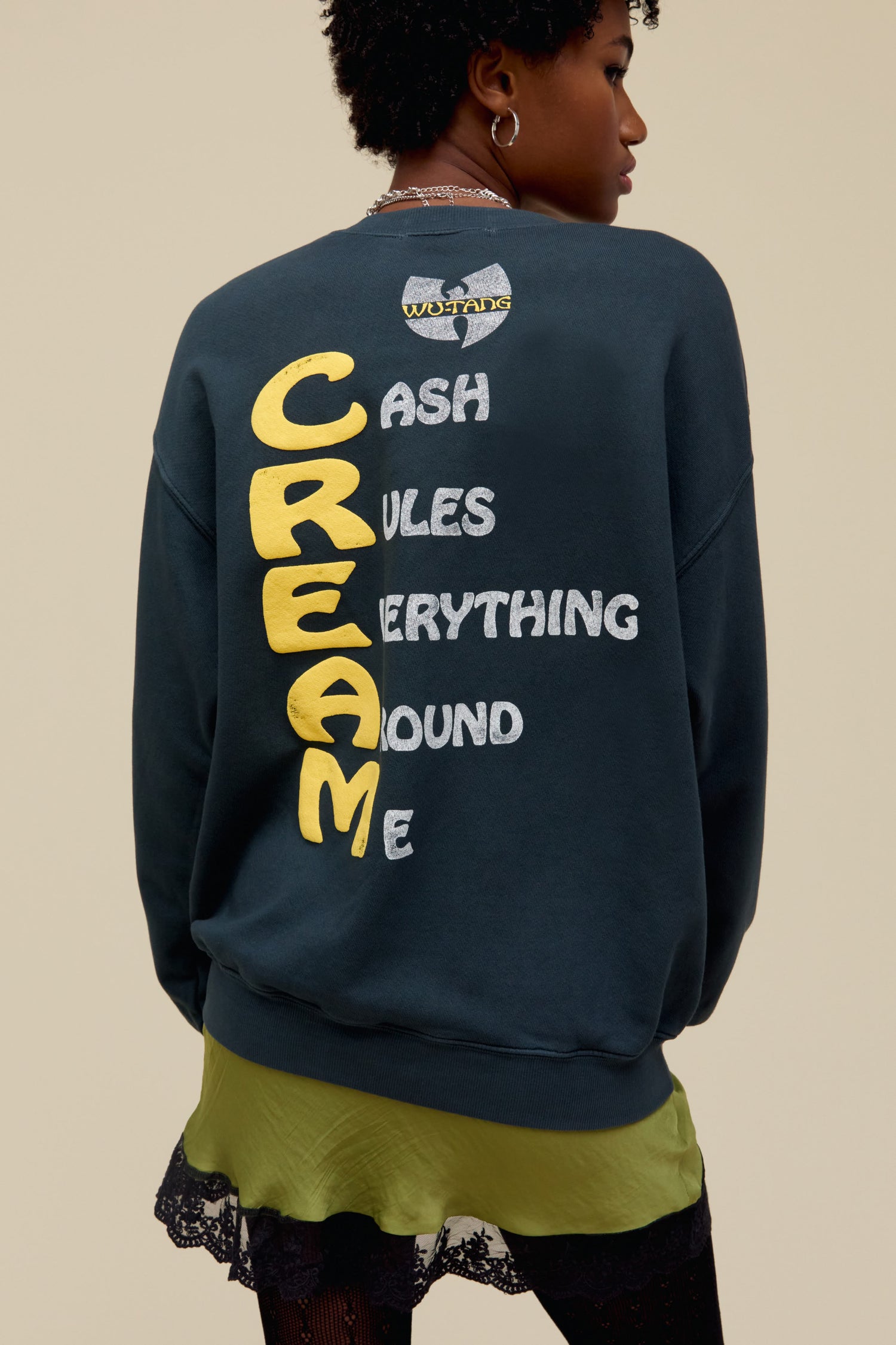 A model featuring a vintage black long sleeve stamped with Wu-tang in front and the cream abbreviation at the back.