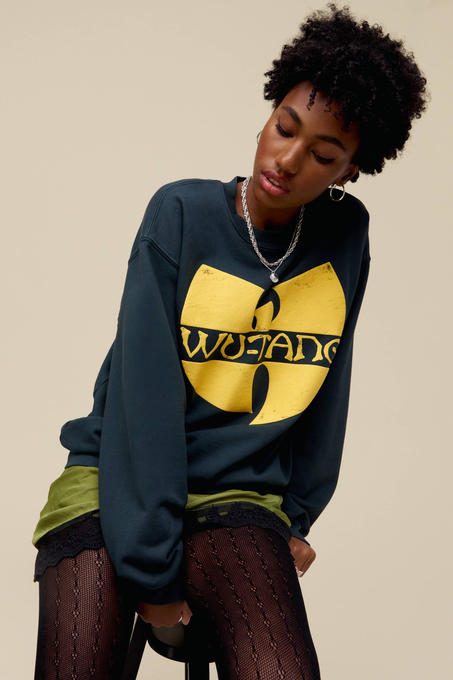 A model featuring a vintage black long sleeve stamped with Wu-tang in front and the cream abbreviation at the back.
