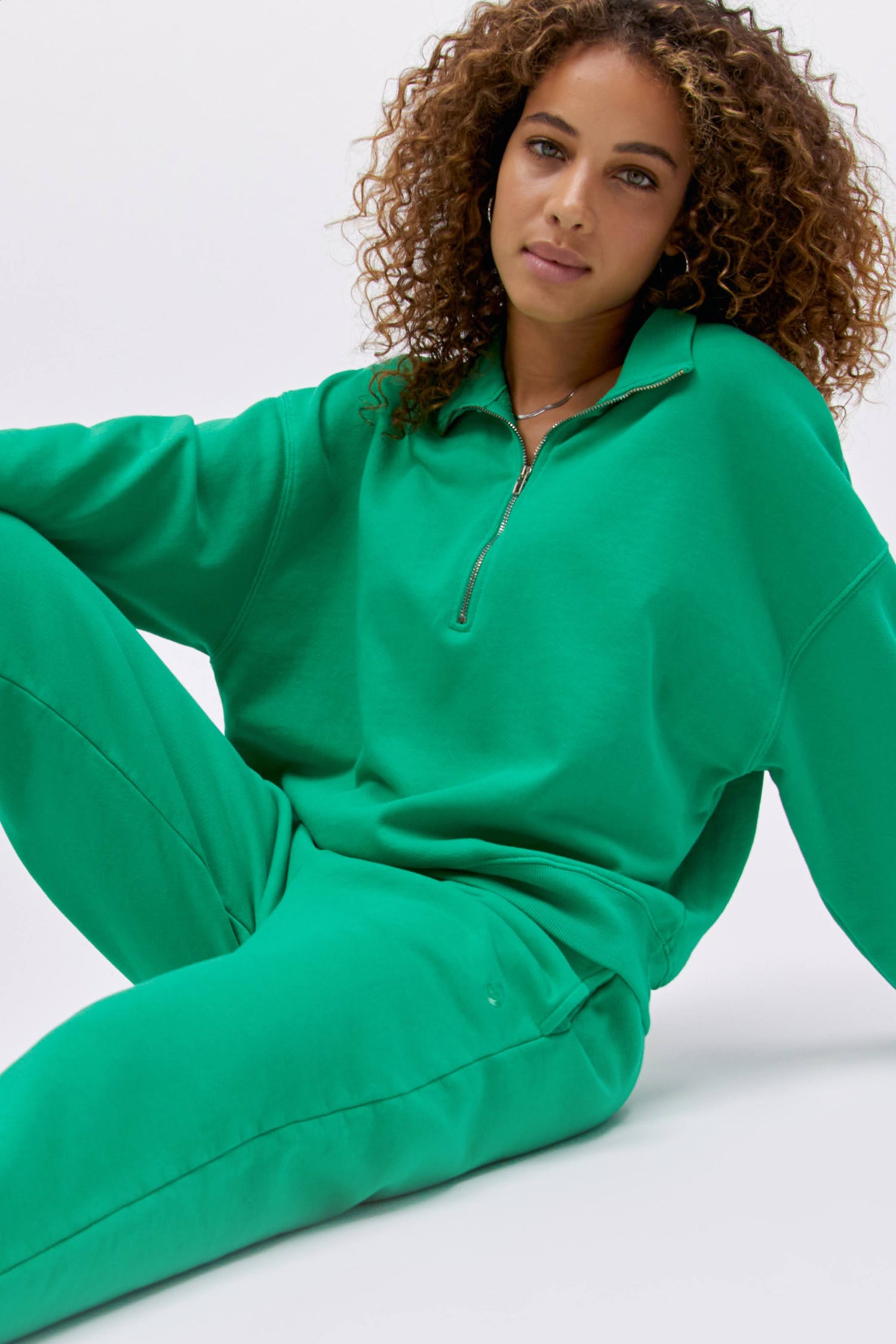 Model wearing a boyfriend sweatpant in lucky green.