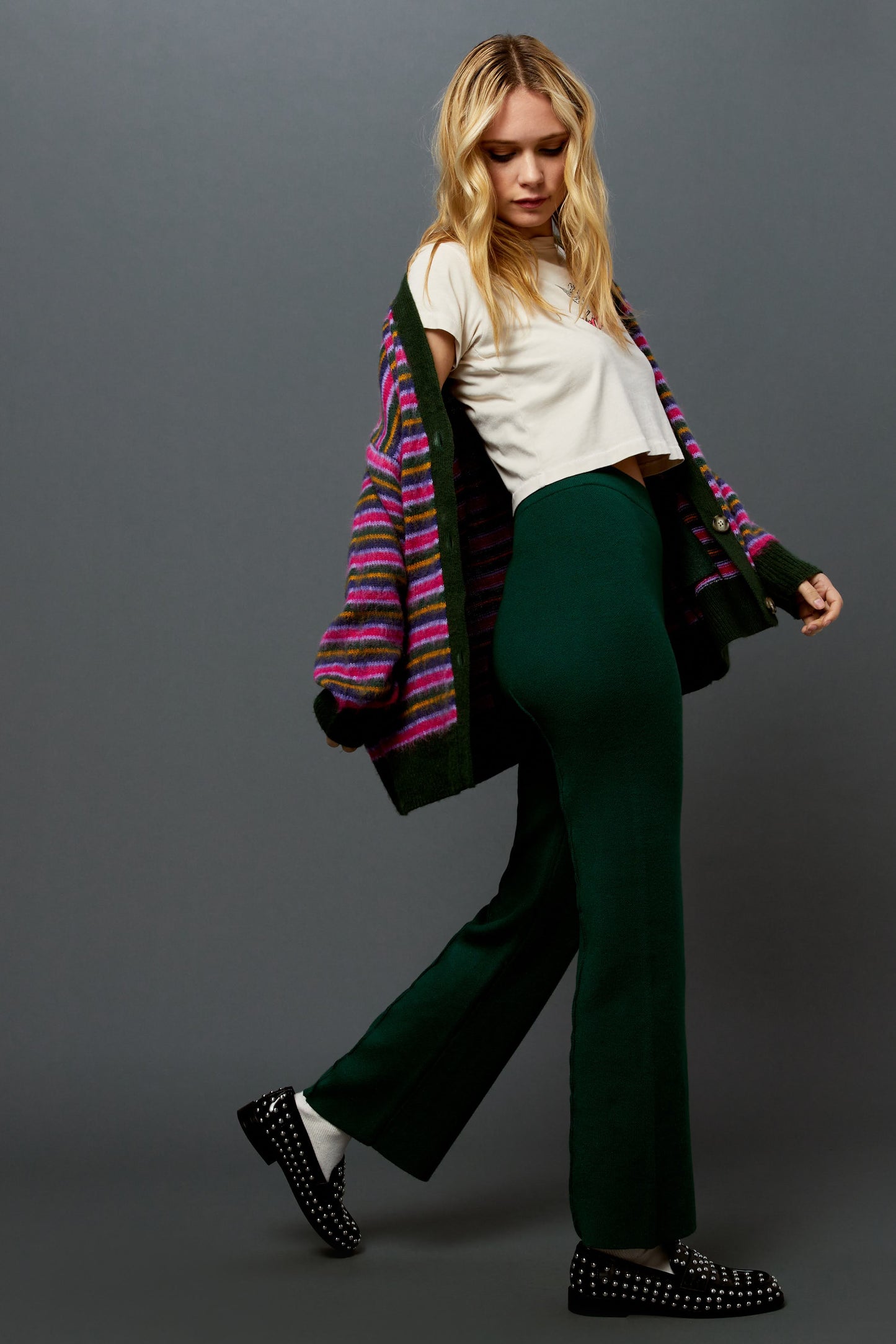 Model wearing a garden bloom striped cardigan with hunter green knit pintuck pants