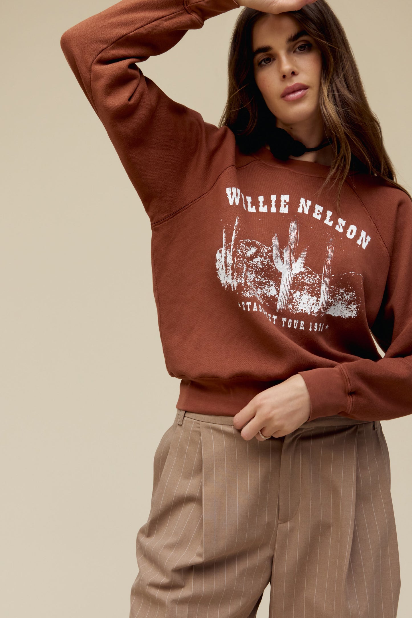 A model featuring a sable long sleeve stamped with Willie Nelson in white large font.