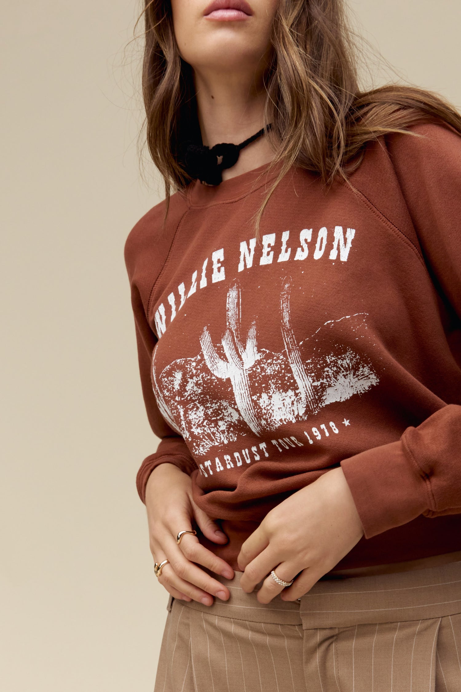 A model featuring a sable long sleeve stamped with Willie Nelson in white large font.